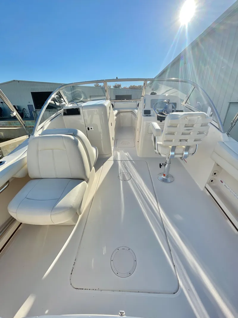 Slide: The Image of 2022 Grady-White Freedom 215 boat interior with white seating and clear blue sky. - 8