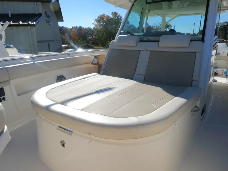 Slide: The Image of 2025 Boston Whaler 380 Outrage boat interior with cushioned seating. - 11