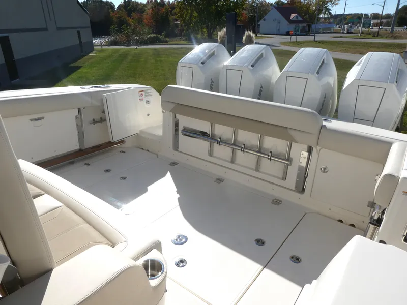 Slide: The Image of 2025 Boston Whaler 380 Outrage boat deck with multiple outboard engines. - 12
