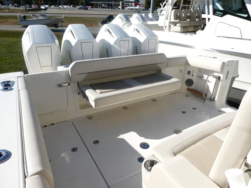 Slide: The Image of 2025 Boston Whaler 380 Outrage boat deck with seating and multiple engines. - 13