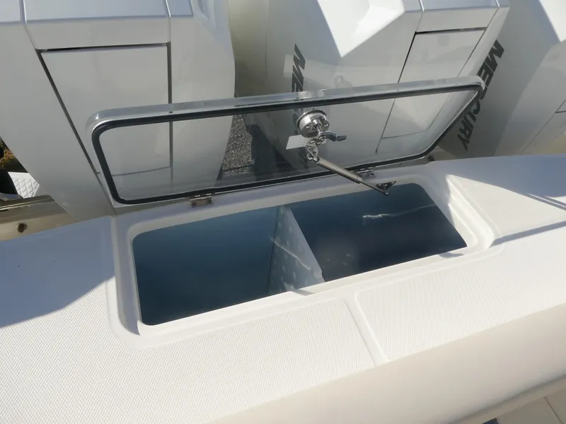 Slide: The Image of Open storage compartment on 2025 Boston Whaler 380 Outrage boat. - 17