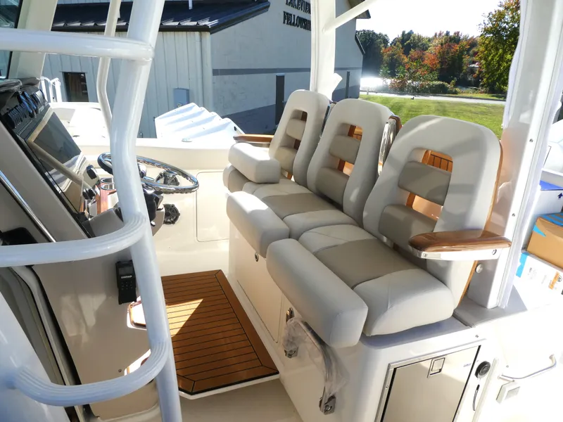 Slide: The Image of 2025 Boston Whaler 380 Outrage boat interior with plush seating and modern helm. - 6