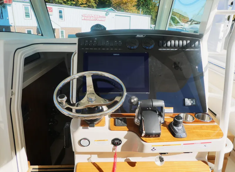 Slide: The Image of 2025 Boston Whaler 380 Outrage helm with modern controls and navigation display. - 8