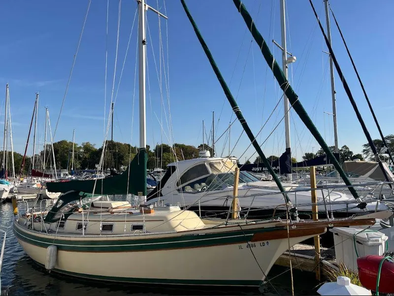 The Image of 1987 Bayfield 32C sailboat docked in a marina under clear blue skies. - 0
