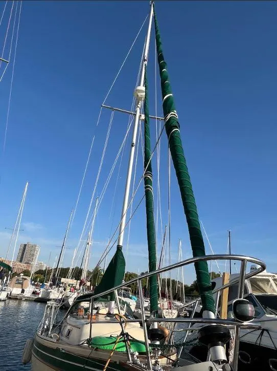 Slide: The Image of 1987 Bayfield 32C sailboat docked in a marina under clear blue skies. - 1