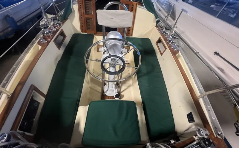 Slide: The Image of 1987 Bayfield 32C sailboat cockpit with green cushions and steering wheel. - 14