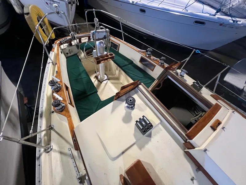 Slide: The Image of 1987 Bayfield 32C sailboat interior with green seating and wooden accents. - 17