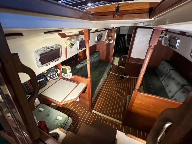Slide: The Image of Interior of 1987 Bayfield 32C sailboat with wood finish and seating area. - 18
