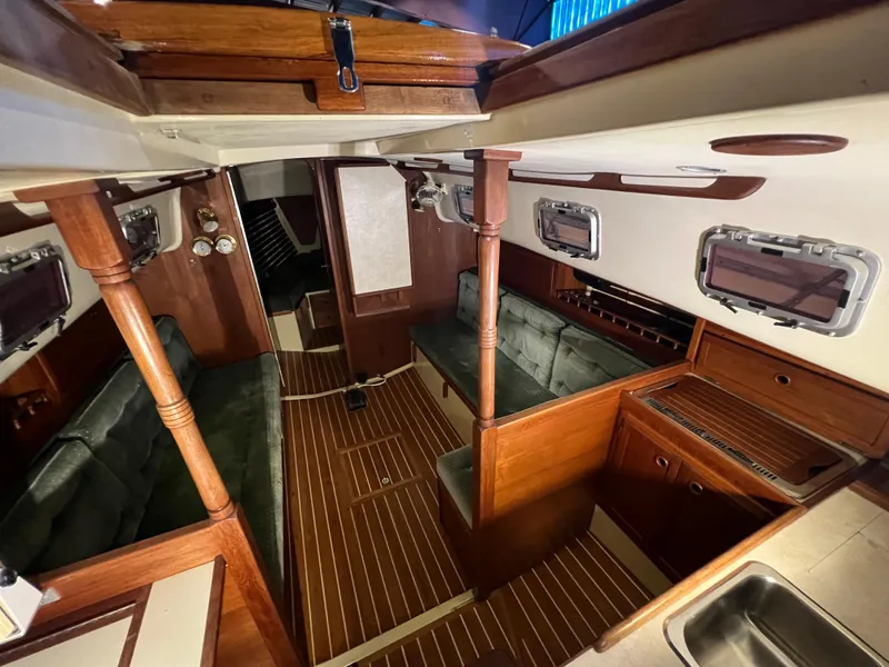 Slide: The Image of Interior of 1987 Bayfield 32C sailboat with wood accents and seating area. - 19