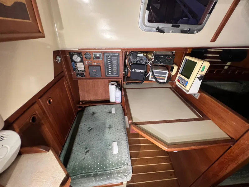 Slide: The Image of 1987 Bayfield 32C sailboat interior with navigation equipment and wooden cabinetry. - 21