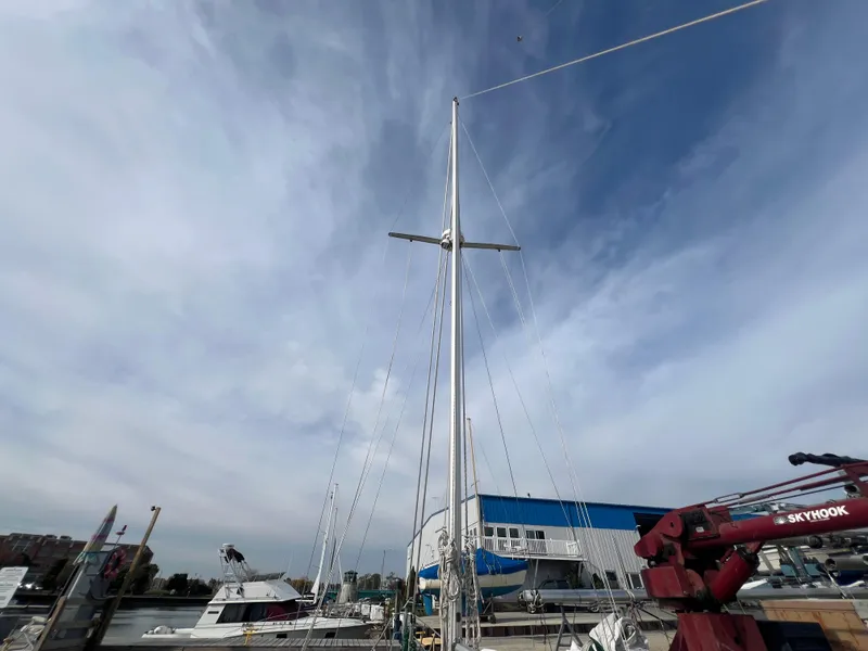 Slide: The Image of 1987 Bayfield 32C sailboat docked at marina under cloudy sky. - 3