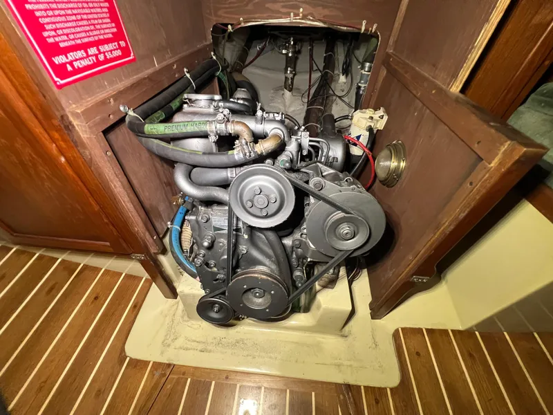 Slide: The Image of Engine compartment of a 1987 Bayfield 32C sailboat, showcasing mechanical components. - 36