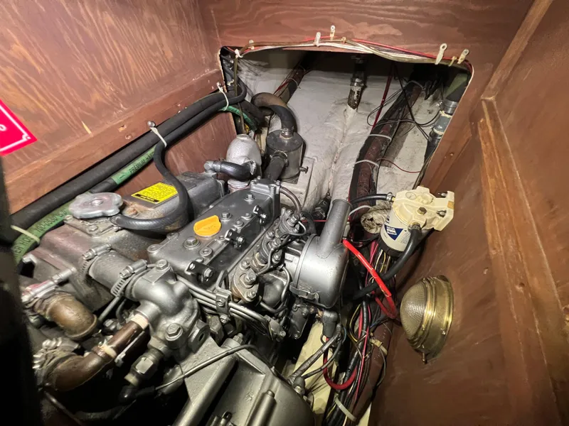 Slide: The Image of Engine compartment of a 1987 Bayfield 32C sailboat, showcasing mechanical components and wiring. - 38