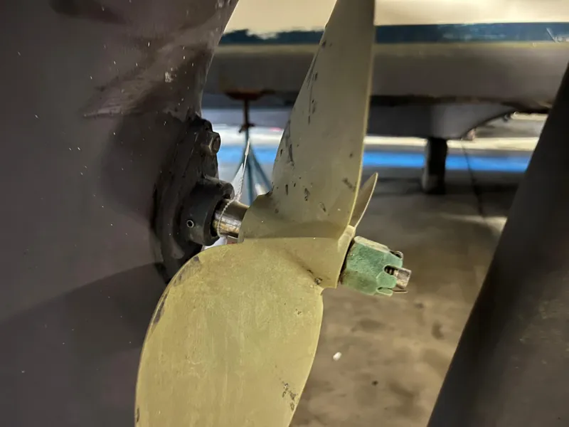 Slide: The Image of Close-up of a 1987 Bayfield 32C boat propeller in a workshop setting. - 47