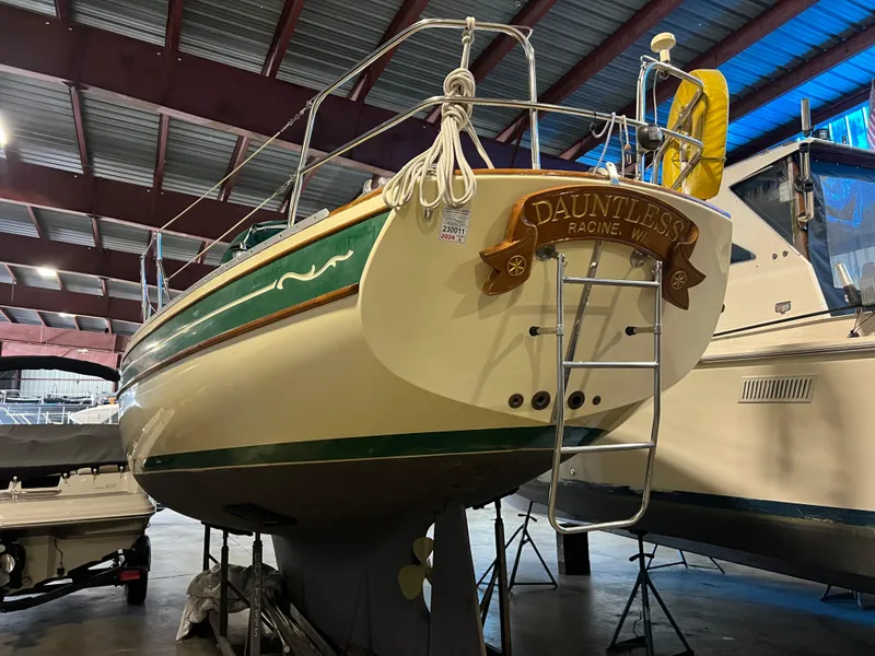Slide: The Image of 1987 Bayfield 32C sailboat in indoor storage, featuring a green and cream hull. - 8