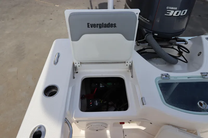 Slide: The Image of Everglades 243 Center Console 2012 boat with open storage compartment and Yamaha 300 engine. - 14