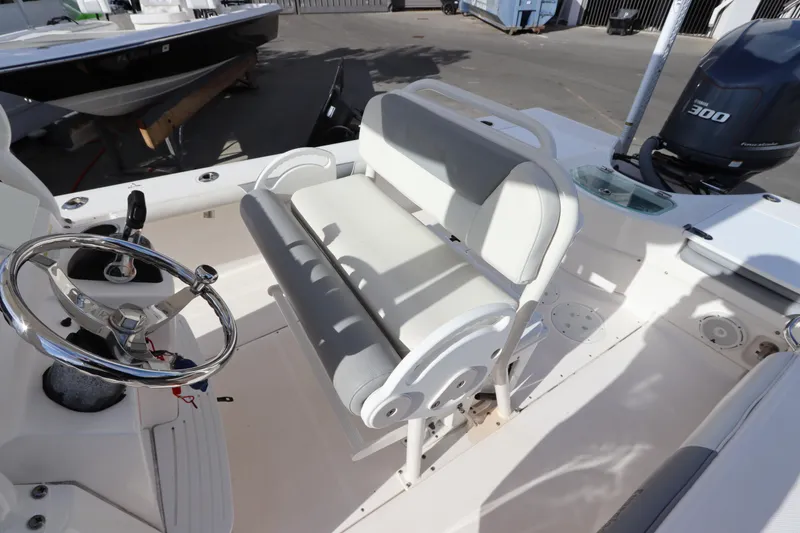 Slide: The Image of 2012 Everglades 243 Center Console boat interior with steering wheel and seating. - 21