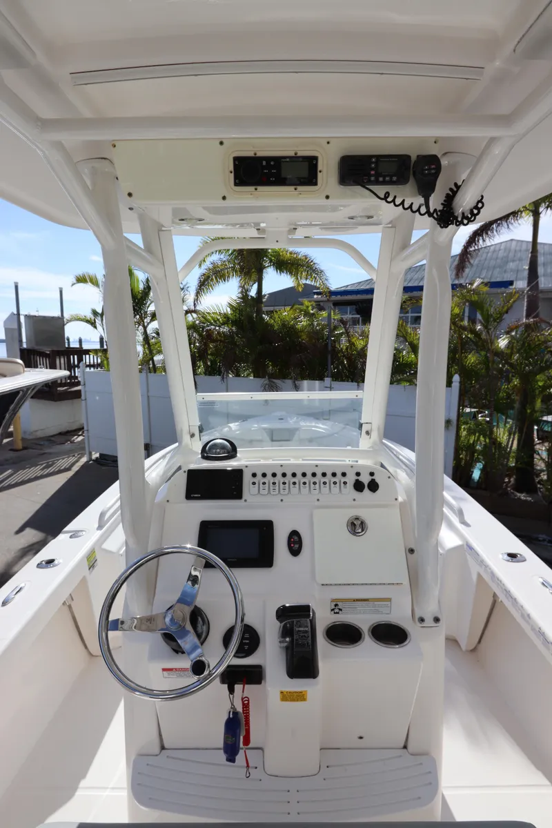Slide: The Image of 2012 Everglades 243 Center Console boat interior with steering wheel and control panel. - 22