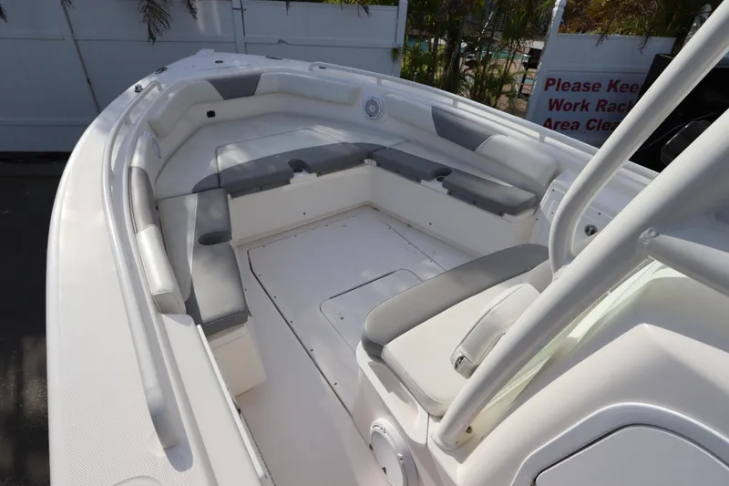 Slide: The Image of 2012 Everglades 243 Center Console boat interior with cushioned seating and clean deck. - 27