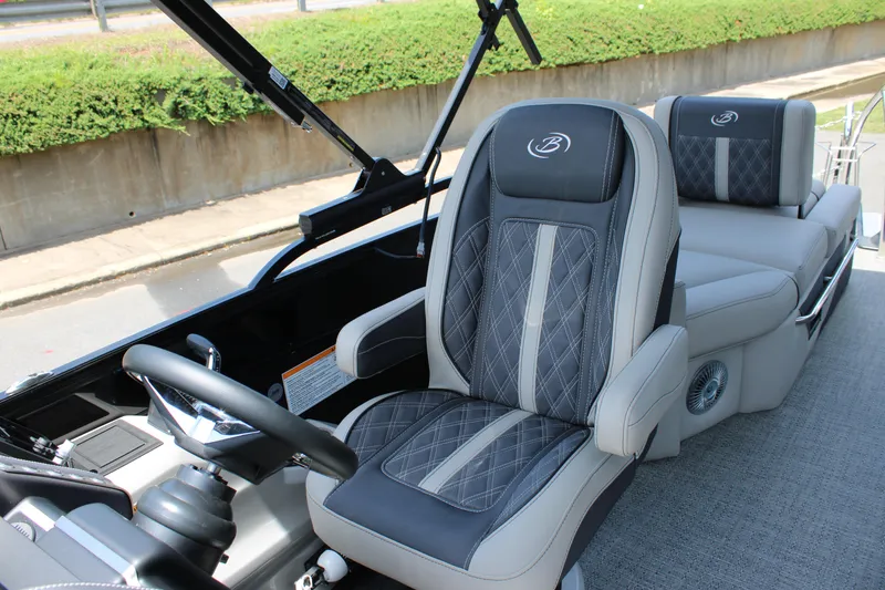 Slide: The Image of 2025 Barletta Lusso 23M boat interior with luxurious seating and modern steering wheel. - 13