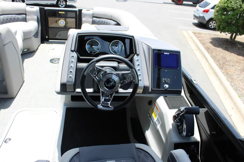Slide: The Image of 2025 Barletta Lusso 23M boat dashboard with steering wheel and control panel. - 14