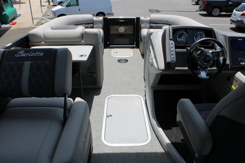 Slide: The Image of 2025 Barletta Lusso 23M boat interior with luxurious seating and modern dashboard. - 15