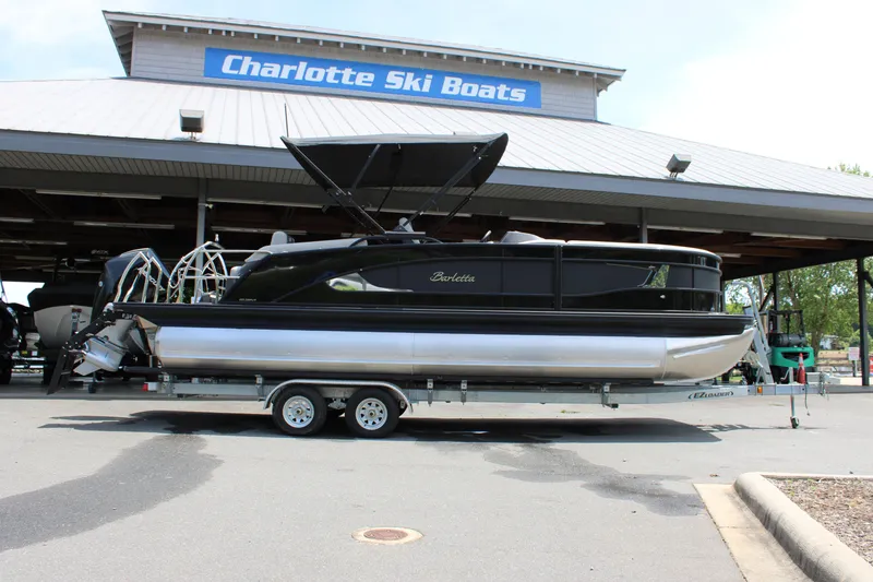 Slide: The Image of 2025 Barletta Lusso 23M pontoon boat on trailer at Charlotte Ski Boats dealership. - 2