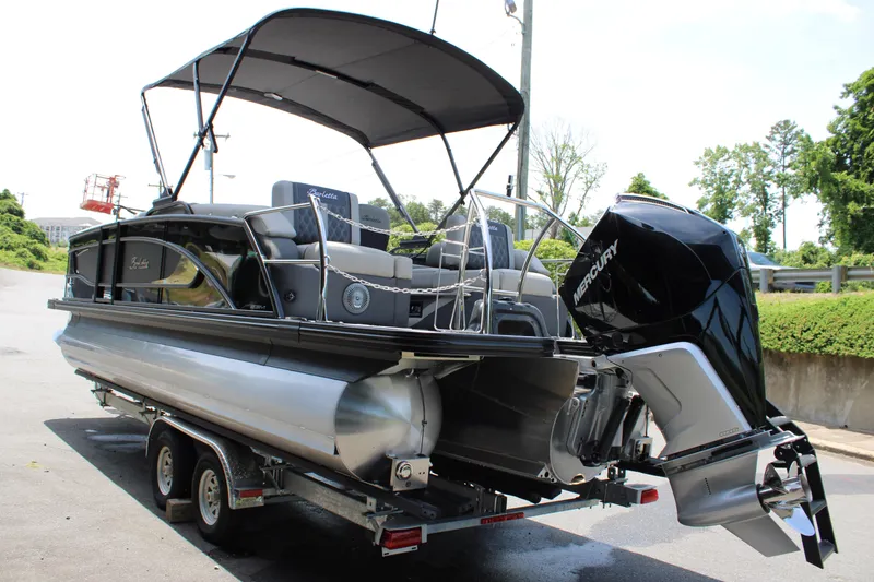 Slide: The Image of 2025 Barletta Lusso 23M pontoon boat on trailer, featuring a Mercury outboard motor. - 5