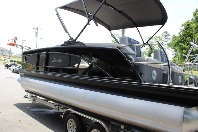 Slide: The Image of 2025 Barletta Lusso 23M pontoon boat with canopy on a trailer. - 6