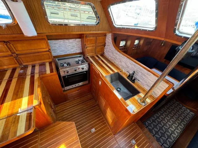 Slide: The Image of Luxurious 1982 King's Legend 41 yacht interior with wooden kitchen and modern appliances. - 14