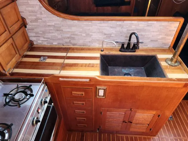 Slide: The Image of Vintage 1982 King's Legend 41 yacht kitchen with wood cabinetry and modern appliances. - 15