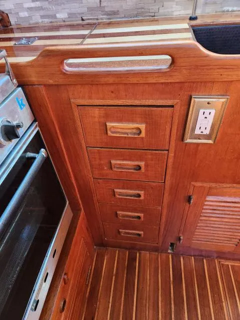 Slide: The Image of Wooden kitchen cabinetry with drawers and outlet in 1982 King's Legend 41 boat. - 19