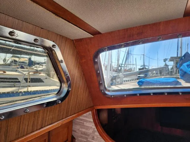 Slide: The Image of Interior view of 1982 Custom King's Legend 41 sailboat with marina through windows. - 20
