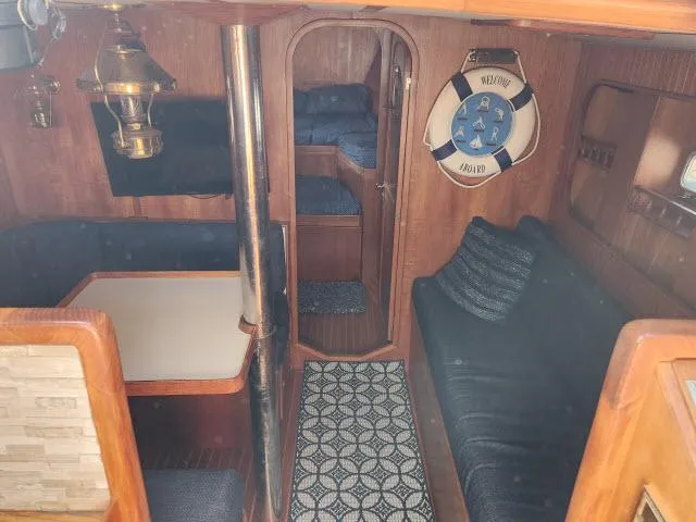 Slide: The Image of Interior of 1982 Custom King's Legend 41 sailboat with cozy seating and nautical decor. - 22