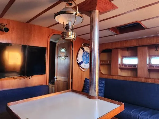 Slide: The Image of Interior of 1982 Custom King's Legend 41 yacht with wood paneling and nautical decor. - 24