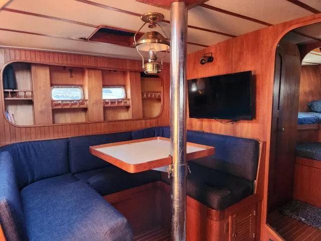 Slide: The Image of Interior of 1982 Custom King's Legend 41 yacht with cozy seating and wooden decor. - 25