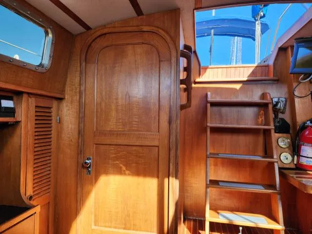 Slide: The Image of Interior of 1982 Custom King's Legend 41 sailboat with wooden finishes and stairs. - 28