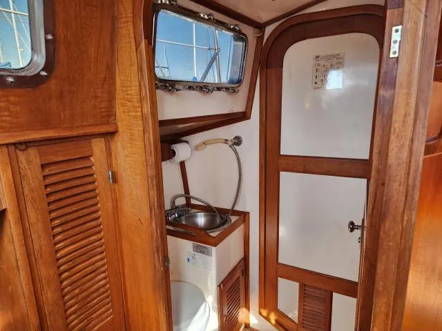 Slide: The Image of 1982 Custom King's Legend 41 yacht bathroom with wooden interior and compact sink. - 29