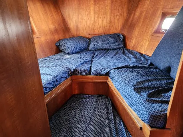 Slide: The Image of Cozy cabin interior of 1982 Custom King's Legend 41 sailboat with blue bedding. - 31