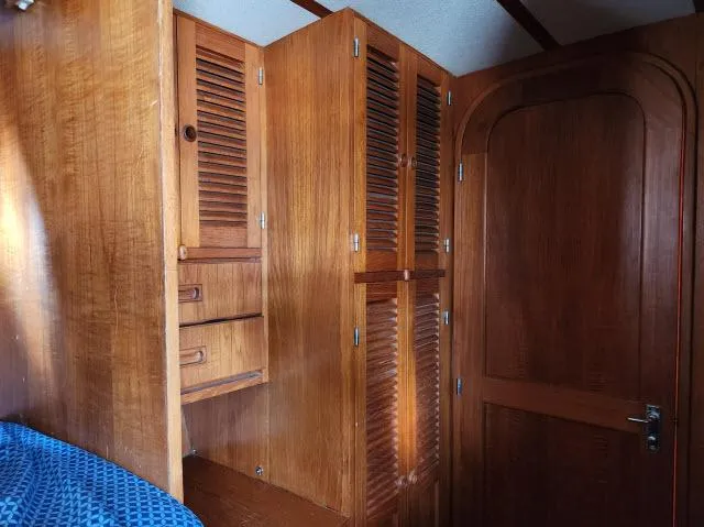 Slide: The Image of Wooden interior of 1982 King's Legend 41 yacht with cabinets and door. - 32