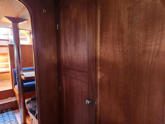 Slide: The Image of Interior of 1982 Custom King's Legend 41 yacht with wooden paneling and seating area. - 33