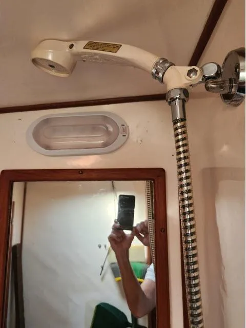 Slide: The Image of 1982 Custom King's Legend 41 yacht bathroom with showerhead and mirror. - 35