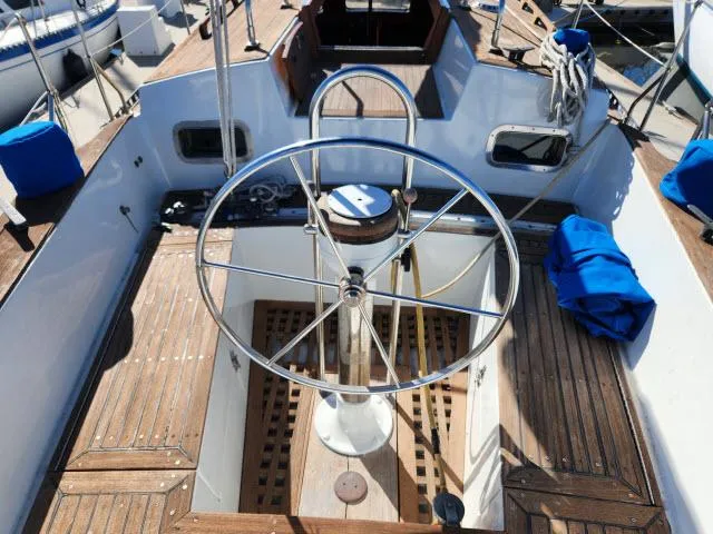 Slide: The Image of Cockpit of 1982 Custom King's Legend 41 sailboat with wooden deck and steering wheel. - 37