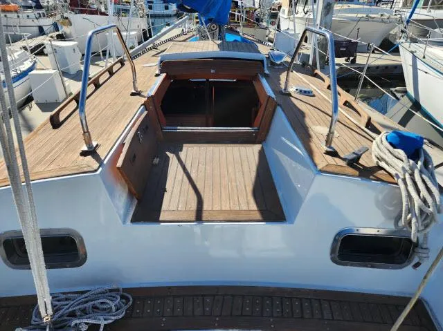 Slide: The Image of 1982 Custom King's Legend 41 sailboat with wooden deck and open cockpit in marina. - 39