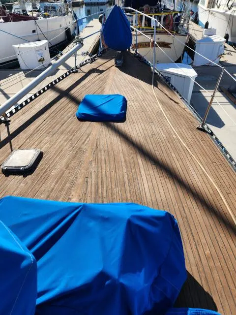 Slide: The Image of 1982 Custom King's Legend 41 sailboat deck with blue covers in marina. - 40