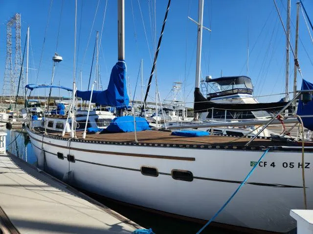 Slide: The Image of 1982 Custom King's Legend 41 sailboat docked in marina, blue covers, clear sky. - 44