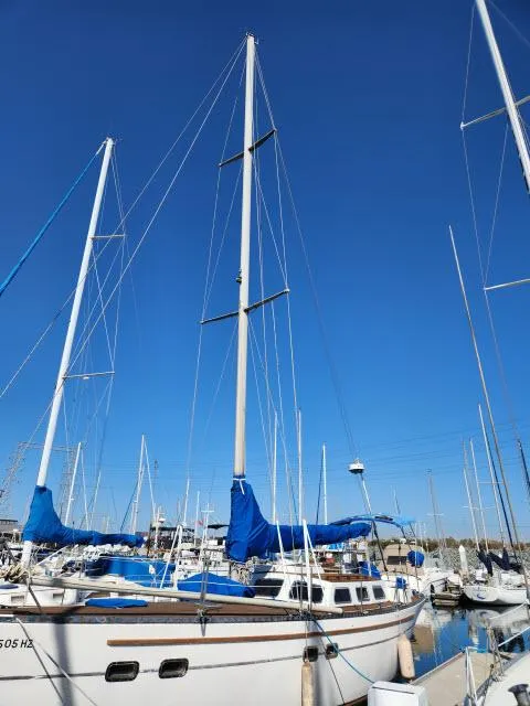 Slide: The Image of Sailboat King's Legend 41, 1982 model, docked in marina under clear blue sky. - 46