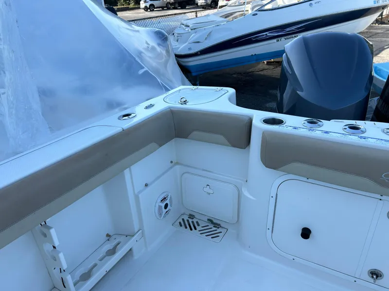 Slide: The Image of 2018 Sailfish 290 CC boat interior with seating and storage compartments. - 14