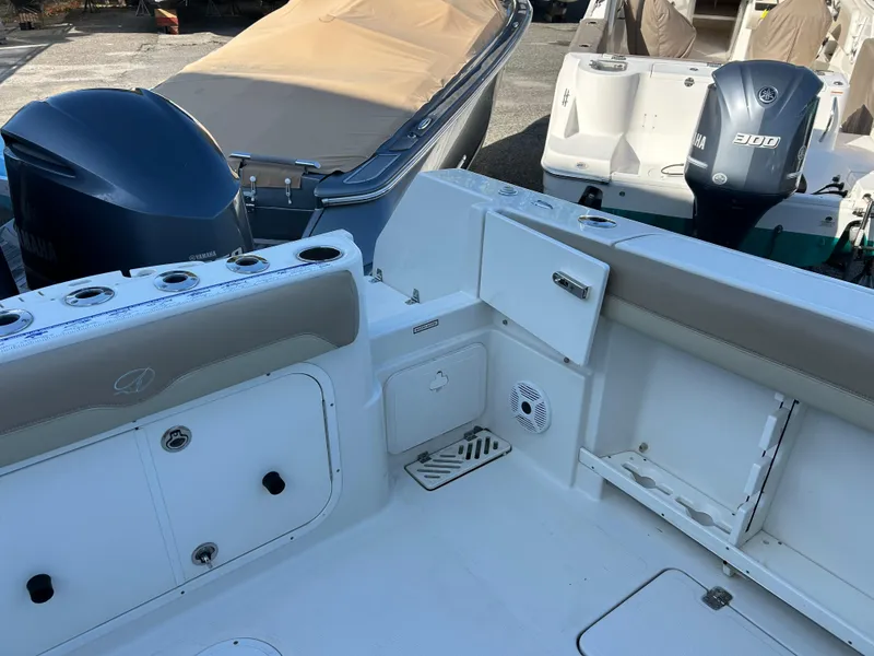 Slide: The Image of 2018 Sailfish 290 CC boat interior with seating and storage compartments. - 16
