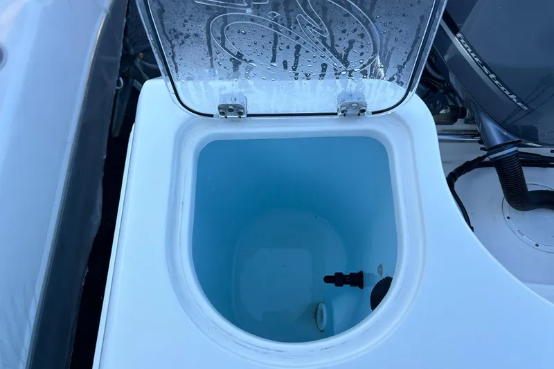 Slide: The Image of Livewell compartment on a 2018 Sailfish 290 CC boat, open lid, showing interior details. - 17
